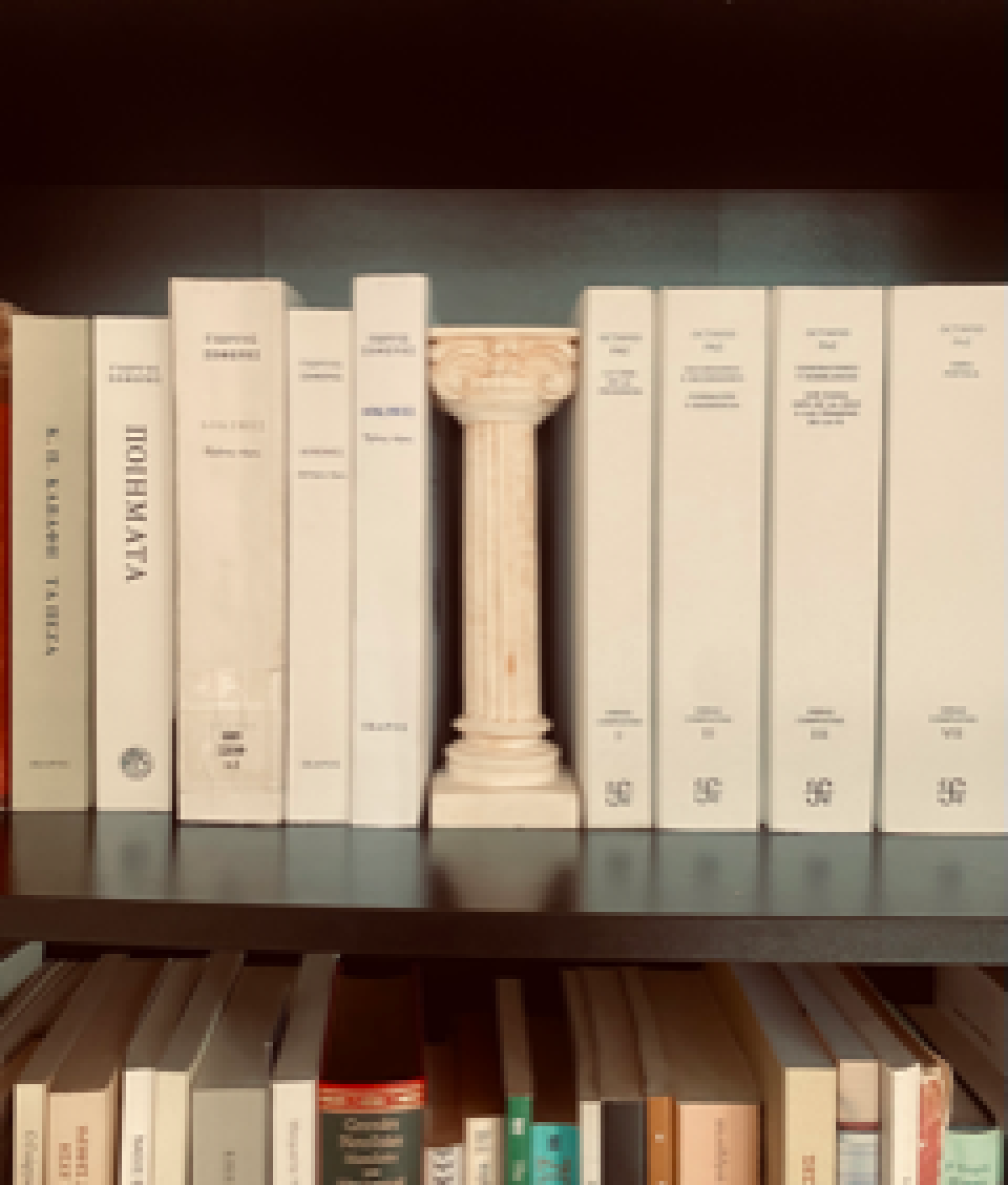 A replica of a doric column placed between stacked books